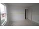 Empty bedroom awaiting personal touches, with natural light from the window and an open door to the house at 1874 Victor Higgins Dr, Shelbyville, IN 46176