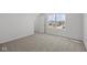 Bedroom with neutral carpet, white walls, and window overlooking a neighborhood street at 1874 Victor Higgins Dr, Shelbyville, IN 46176