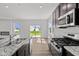 Kitchen with granite counters, stainless appliances, and sliding glass doors to patio at 1874 Victor Higgins Dr, Shelbyville, IN 46176