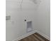 An empty laundry room features white walls, hookups, and wire rack shelving ready for appliances and organization at 1874 Victor Higgins Dr, Shelbyville, IN 46176