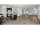 Open floor plan with kitchen island and light-colored wood floors at 1874 Victor Higgins Dr, Shelbyville, IN 46176