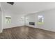 Bright living room with wood floors, modern fireplace, and lots of natural light from multiple windows at 1874 Victor Higgins Dr, Shelbyville, IN 46176