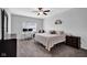 Cozy bedroom with a neutral color palette, ceiling fan, and a comfortable queen-sized bed at 2006 Monticlair Ln, Columbus, IN 47201