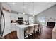 Bright kitchen with white cabinets, stainless steel appliances, and an island with bar seating at 2006 Monticlair Ln, Columbus, IN 47201