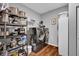 Well-organized laundry room with modern washer/dryer, shelving, and ample storage space at 2006 Monticlair Ln, Columbus, IN 47201