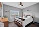 A calming main bedroom with neutral walls, a four-poster bed, and a bright window at 2006 Monticlair Ln, Columbus, IN 47201