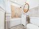 Tiled bathroom with a tub-shower combo, white vanity, and a decorative mirror at 2011 Sheffield Ave, Anderson, IN 46011
