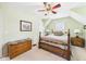 Cozy bedroom with a wood bed frame, wood dresser, and sloped ceilings at 2011 Sheffield Ave, Anderson, IN 46011