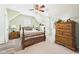 Comfortable bedroom with a wood bed frame, wood dresser, and sloped ceilings at 2011 Sheffield Ave, Anderson, IN 46011