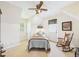 Bright bedroom with a single bed, ceiling fan, a rocking chair, and an exterior door at 2011 Sheffield Ave, Anderson, IN 46011