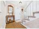 Foyer with wood floors, stairs, vintage lamp, mirror, and a front door at 2011 Sheffield Ave, Anderson, IN 46011