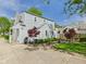 Charming two-story home with light blue siding, a well-manicured lawn, and mature trees at 2011 Sheffield Ave, Anderson, IN 46011