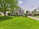 Inviting light blue home with a well-kept lawn and mature landscaping at 2011 Sheffield Ave, Anderson, IN 46011