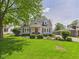 Charming light blue home with stone accents and a well-manicured front yard at 2011 Sheffield Ave, Anderson, IN 46011