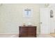 Hallway featuring decorative walls, an accent window, and access to the bathroom at 2011 Sheffield Ave, Anderson, IN 46011