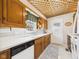 Charming kitchen features wood cabinets, white countertops, and a unique lattice ceiling design at 2011 Sheffield Ave, Anderson, IN 46011