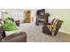 Living room with carpeting, two leather recliners, and fireplace at 2011 Sheffield Ave, Anderson, IN 46011
