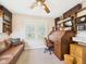 Inviting office featuring a roll-top desk, leather sofa, shelving, and lots of natural light at 2011 Sheffield Ave, Anderson, IN 46011