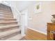 Carpeted stairs and hardwood floors, leading to the upper level of the home at 2011 Sheffield Ave, Anderson, IN 46011