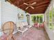 Inviting sunroom with brick floors, a swing, and comfortable wicker furniture at 2011 Sheffield Ave, Anderson, IN 46011