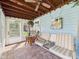 Bright sunroom with brick floors, a ceiling fan, and a cozy seating area at 2011 Sheffield Ave, Anderson, IN 46011