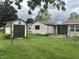 Lush backyard view with shed and covered patio area, ideal for outdoor relaxation at 211 Woodlane Dr, Columbus, IN 47201