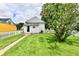Backyard with a grassy area, a white picket fence, and access to the house at 2335 Main St, Elwood, IN 46036