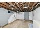 Unfinished basement area with concrete walls, exposed ceiling beams and access to utility systems at 2335 Main St, Elwood, IN 46036