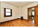 Bright bedroom featuring hardwood floors, a window and an open doorway at 2335 Main St, Elwood, IN 46036