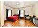 Bright bedroom with wood floors, large windows, and a comfortable workspace at 2335 Main St, Elwood, IN 46036