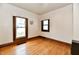 Cozy bedroom showcasing hardwood floors and natural light from two windows at 2335 Main St, Elwood, IN 46036