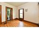 Bedroom with bathroom access, featuring wood floors and trim at 2335 Main St, Elwood, IN 46036