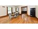 Dining area with wood floors, trim and a table with six chairs near multiple doorways at 2335 Main St, Elwood, IN 46036