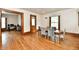 Dining area with wood floors, trim and a table with six chairs near multiple doorways at 2335 Main St, Elwood, IN 46036