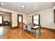 Dining area with wood floors, trim and a table with six chairs near multiple doorways at 2335 Main St, Elwood, IN 46036