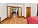 Hallway with original wood trim and hardwood floors, connecting rooms at 2335 Main St, Elwood, IN 46036