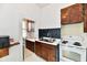 Functional kitchen with wood cabinets, stainless steel sink, and open shelving at 2335 Main St, Elwood, IN 46036