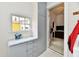 Practical laundry area with gray cabinets, a countertop, and a window at 2335 Main St, Elwood, IN 46036