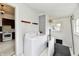 Bright laundry room features a washer and dryer, white walls, and access to the basement at 2335 Main St, Elwood, IN 46036