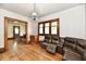Comfortable living room featuring hardwood floors and a large leather sofa at 2335 Main St, Elwood, IN 46036