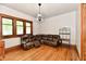 Cozy living room with hardwood floors and a spacious, plush leather sectional at 2335 Main St, Elwood, IN 46036