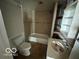 A bathroom with a shower and tub combination, as well as a vintage sink and medicine cabinet at 2701 N Gale St, Indianapolis, IN 46218