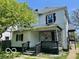 Two-story home showcasing a covered porch and a partially brick facade at 2701 N Gale St, Indianapolis, IN 46218