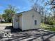 Garage exterior with neutral colored siding, a side door, and a window at 2701 N Gale St, Indianapolis, IN 46218