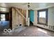 Spacious living room area with hardwood floors, awaiting renovation at 2701 N Gale St, Indianapolis, IN 46218