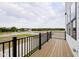 Exterior balcony view with black metal railing overlooking nearby homesites and greenery at 3279 Morab Dr, Zionsville, IN 46077
