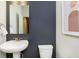 Stylish half-bathroom features a pedestal sink, neutral colors, and modern decor at 3279 Morab Dr, Zionsville, IN 46077