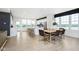 Bright, open dining and kitchen area features ample seating, a large island, and natural light at 3279 Morab Dr, Zionsville, IN 46077