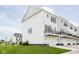 A modern townhome with a white exterior, black trim, a balcony, and a two-car garage at 3279 Morab Dr, Zionsville, IN 46077