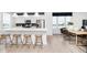 Modern kitchen featuring a breakfast bar with stools, stainless steel appliances, and an adjacent dining area at 3279 Morab Dr, Zionsville, IN 46077